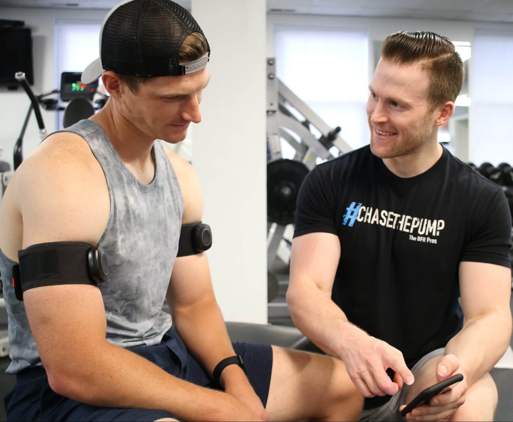 Dr. Nicholas Rolnick coaching a client with BFR cuffs on